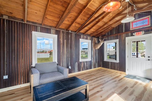 unfurnished room featuring hardwood / wood-style floors, vaulted ceiling with beams, wood walls, and wood ceiling