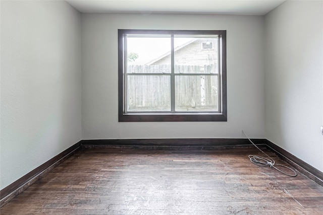 spare room with dark hardwood / wood-style floors