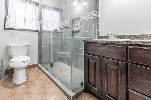 bathroom with vanity, an enclosed shower, and toilet