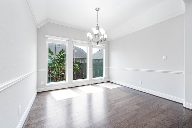 unfurnished room with a notable chandelier, dark hardwood / wood-style flooring, ornamental molding, and lofted ceiling