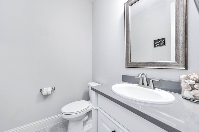 bathroom featuring tile patterned flooring, vanity, and toilet