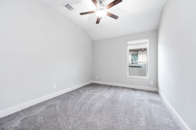 empty room with carpet, ceiling fan, and vaulted ceiling