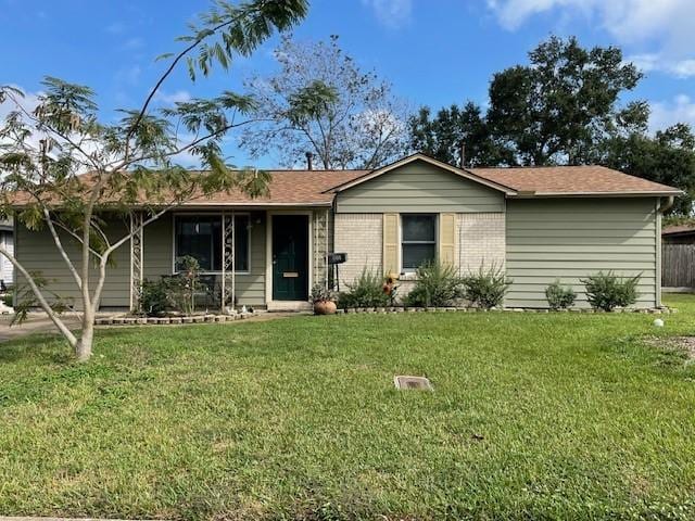 ranch-style home with a front lawn