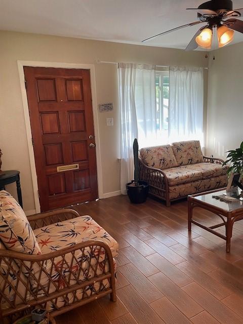 living room featuring hardwood / wood-style flooring and ceiling fan