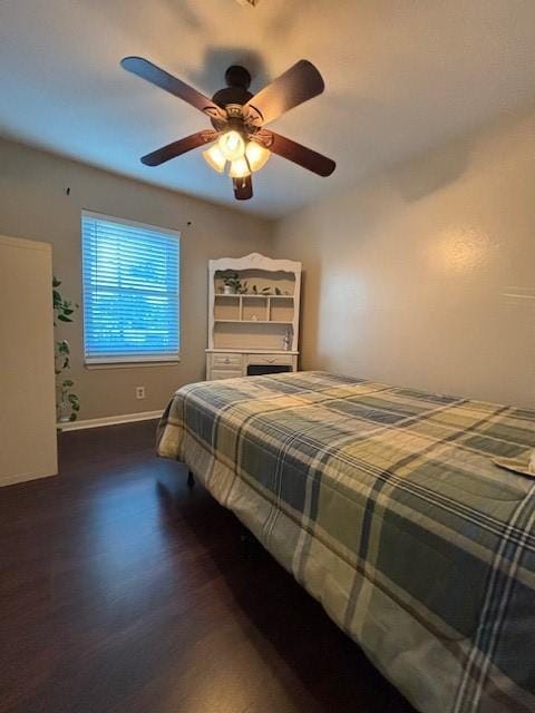 bedroom featuring dark hardwood / wood-style flooring and ceiling fan