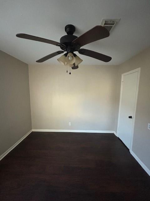 unfurnished room with dark hardwood / wood-style floors and ceiling fan