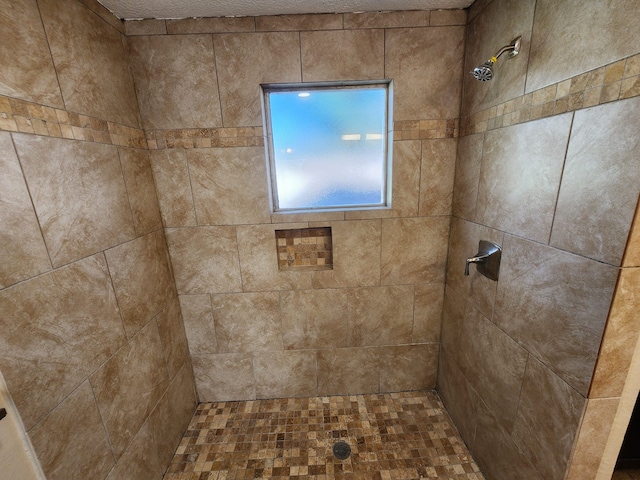 bathroom with a tile shower