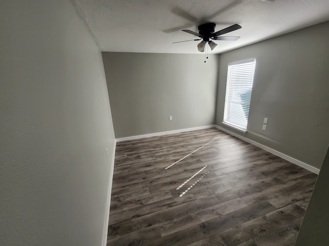 spare room featuring a textured ceiling, ceiling fan, and dark hardwood / wood-style floors