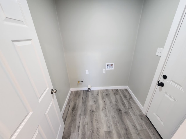 clothes washing area with washer hookup, light hardwood / wood-style flooring, and gas dryer hookup