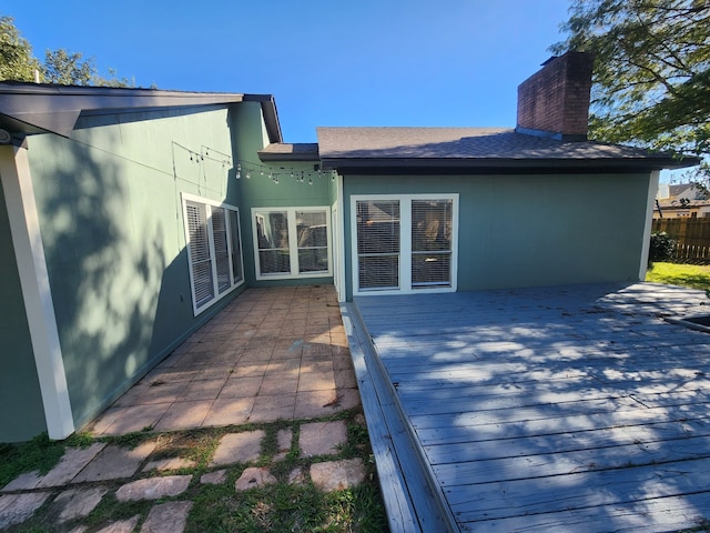 rear view of house with a wooden deck