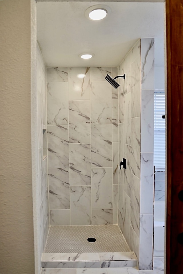 bathroom with tiled shower