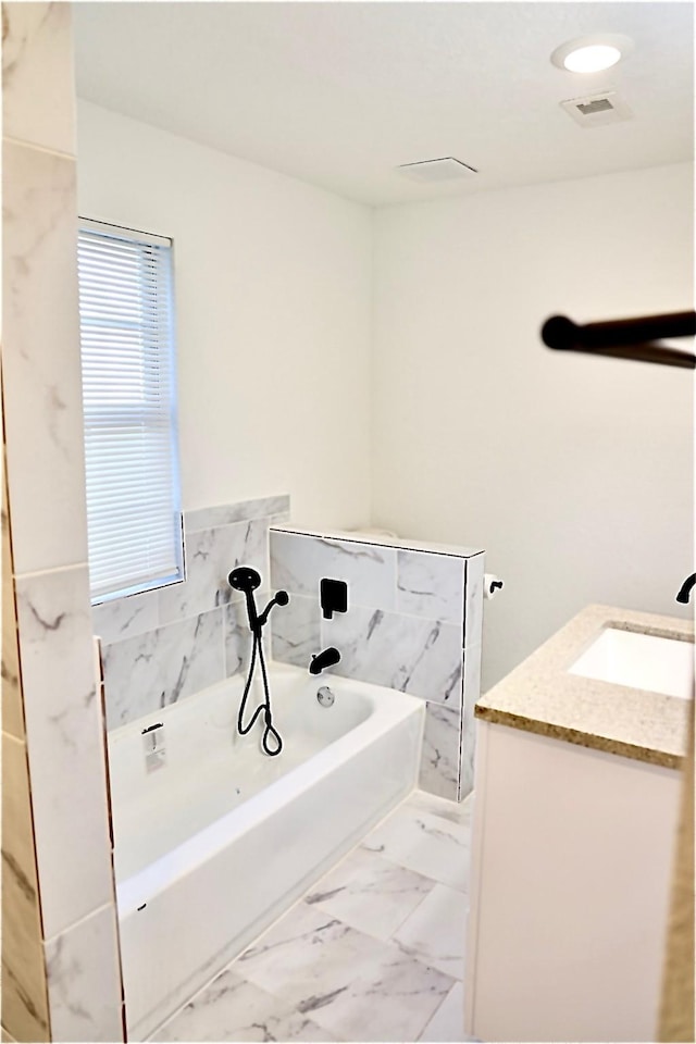 bathroom featuring vanity and a bathtub