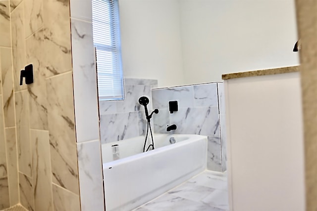 bathroom featuring tile walls and tiled shower / bath