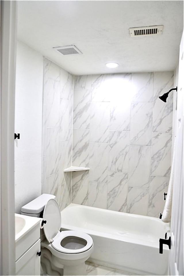 full bathroom featuring vanity, toilet, and tiled shower / bath combo