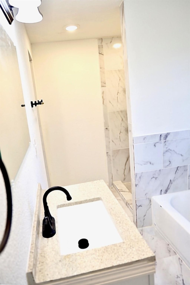 bathroom with tile walls, sink, and independent shower and bath