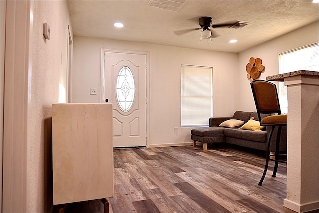 foyer with hardwood / wood-style flooring, ceiling fan, and a textured ceiling