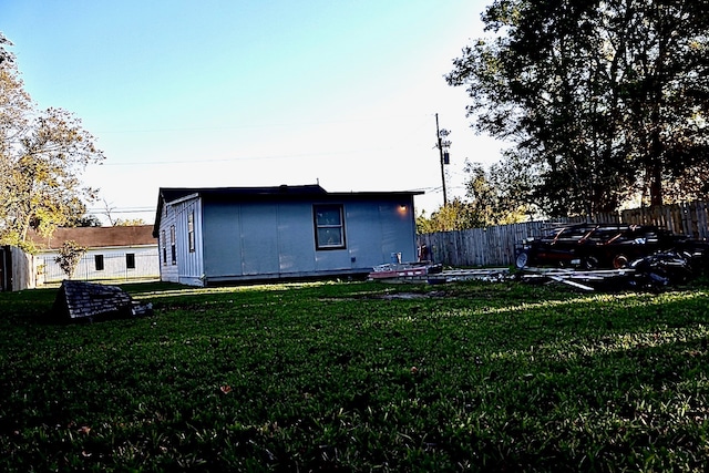 rear view of property with a lawn