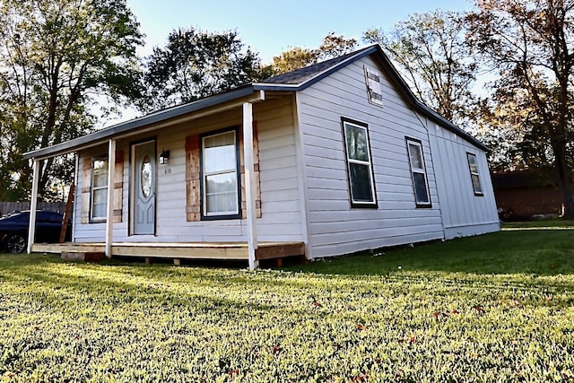 exterior space featuring a lawn and covered porch