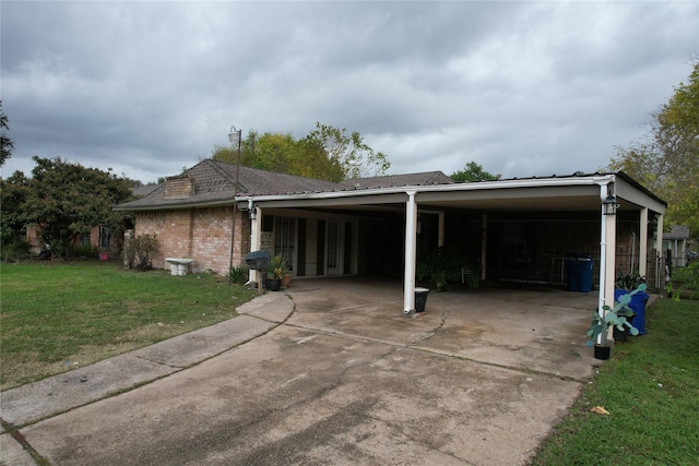 exterior space with a lawn and a carport