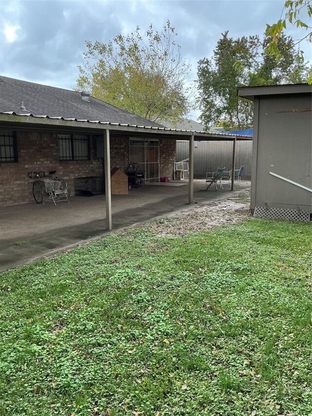 view of yard featuring a patio area and an outdoor structure