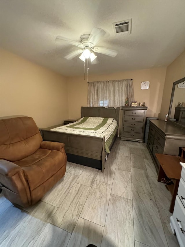 bedroom with visible vents and a ceiling fan