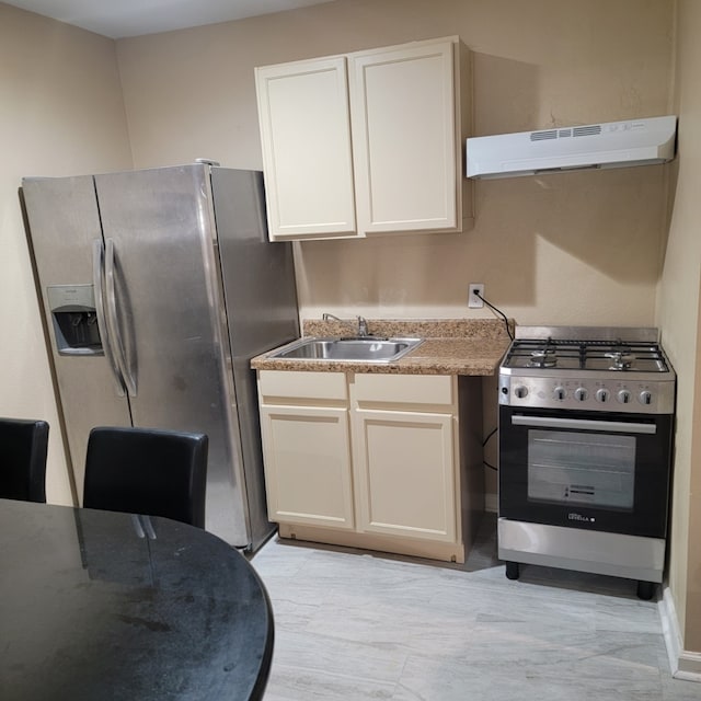 kitchen with appliances with stainless steel finishes, a sink, white cabinetry, and under cabinet range hood