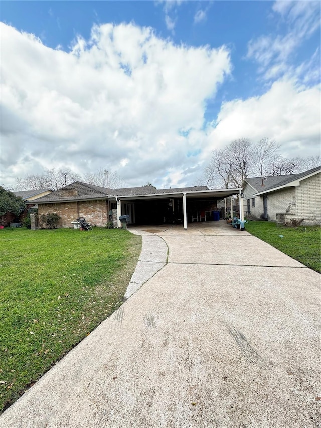 single story home with driveway, a front lawn, a carport, and brick siding