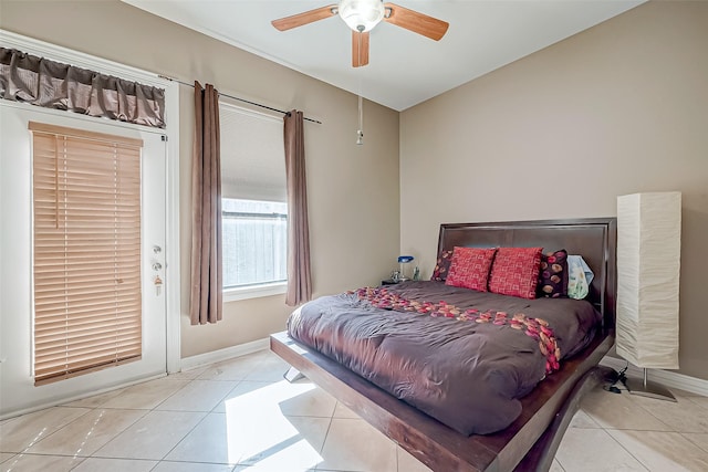 tiled bedroom featuring ceiling fan