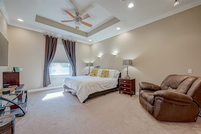 carpeted bedroom featuring a tray ceiling, ceiling fan, and ornamental molding