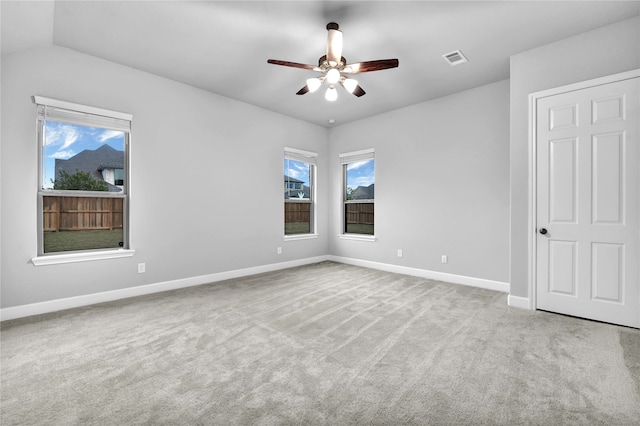 unfurnished bedroom with ceiling fan, light colored carpet, and lofted ceiling