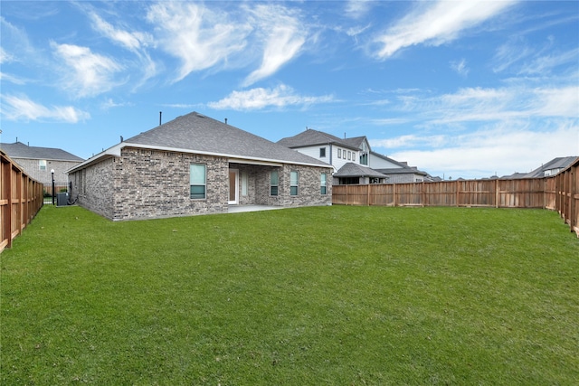 rear view of property with central AC, a yard, and a patio