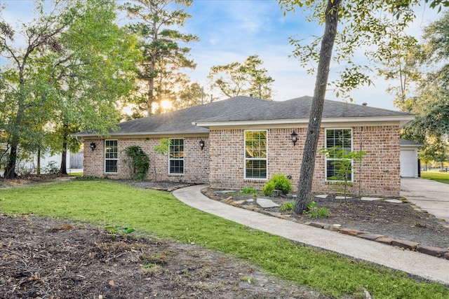 view of front of home featuring a garage and a front lawn