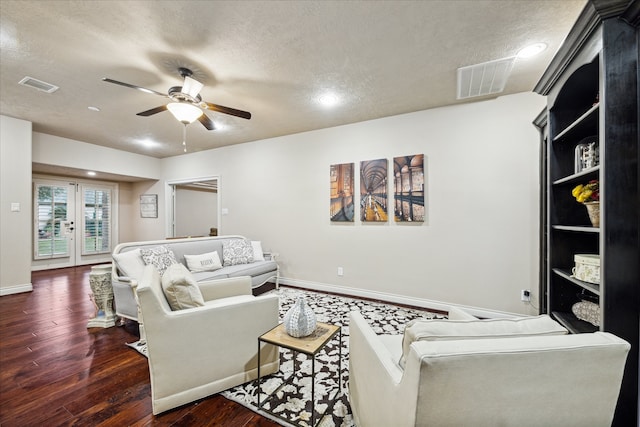 living room with french doors, ceiling fan, dark hardwood / wood-style flooring, and a textured ceiling