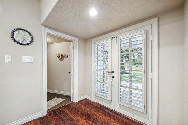 doorway to outside with french doors, dark hardwood / wood-style flooring, and a textured ceiling