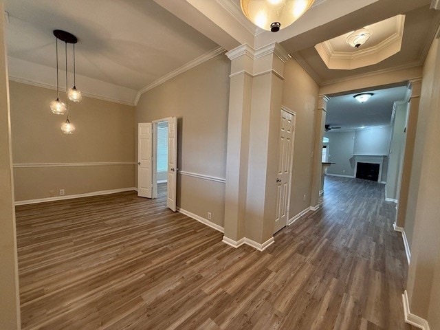 hall with ornamental molding, dark wood-type flooring, and ornate columns