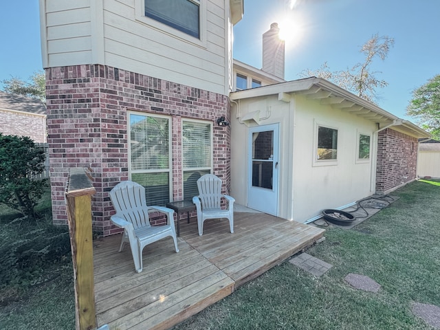 wooden deck featuring a lawn