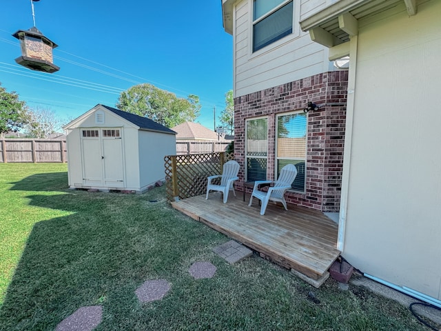 view of yard with a deck and a storage unit