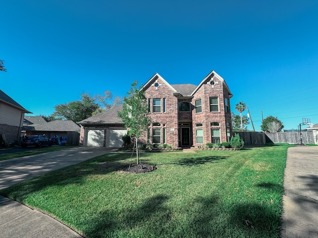 view of front of property featuring a front yard and a garage