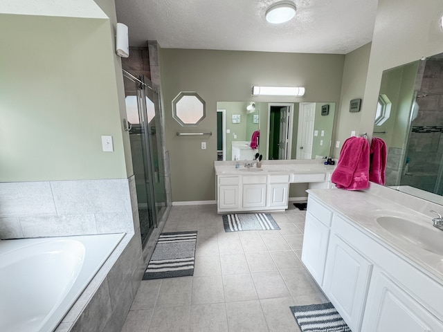 bathroom with tile patterned floors, vanity, shower with separate bathtub, and a textured ceiling