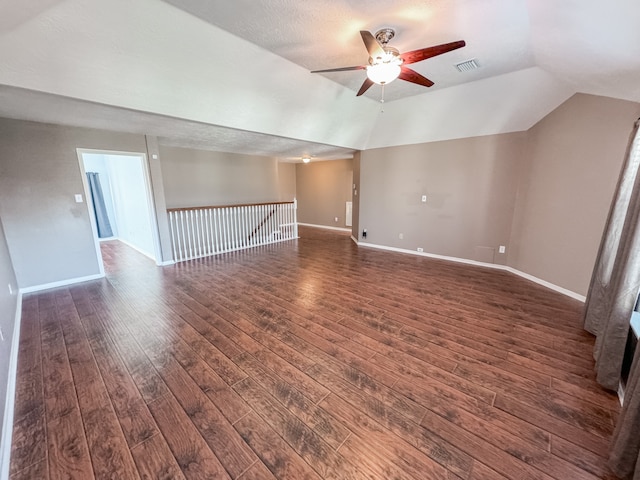 additional living space featuring a textured ceiling, dark hardwood / wood-style floors, ceiling fan, and lofted ceiling