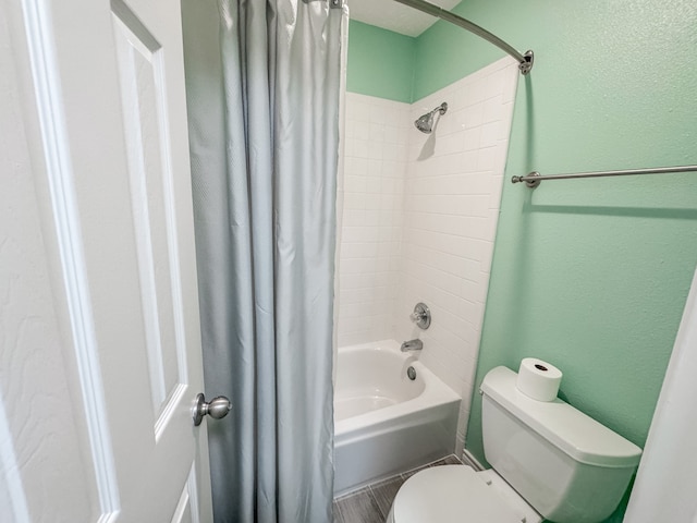 bathroom with shower / bath combo and toilet