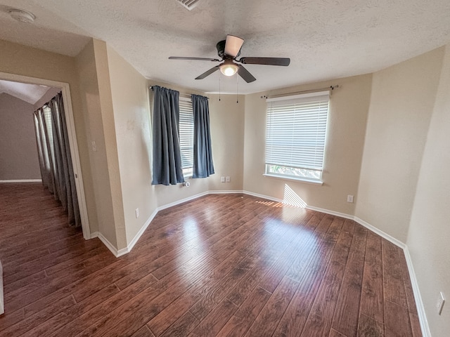 unfurnished room featuring a textured ceiling, ceiling fan, and dark wood-type flooring