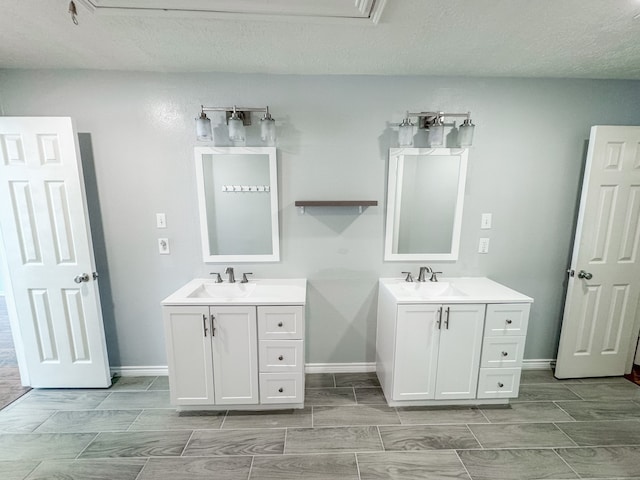 bathroom featuring a textured ceiling and vanity