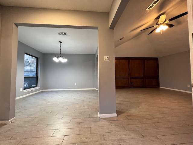 unfurnished room featuring vaulted ceiling, light hardwood / wood-style floors, and ceiling fan with notable chandelier