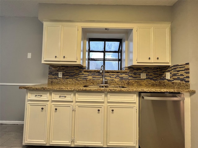 kitchen featuring white cabinets, decorative backsplash, stainless steel dishwasher, and sink