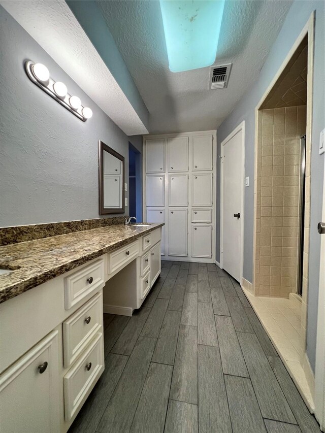 bathroom featuring vanity and a textured ceiling