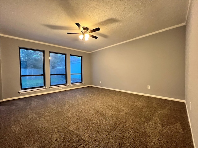 unfurnished room featuring ceiling fan, crown molding, a textured ceiling, and dark colored carpet