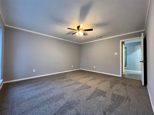 spare room featuring ceiling fan, carpet, a textured ceiling, and ornamental molding