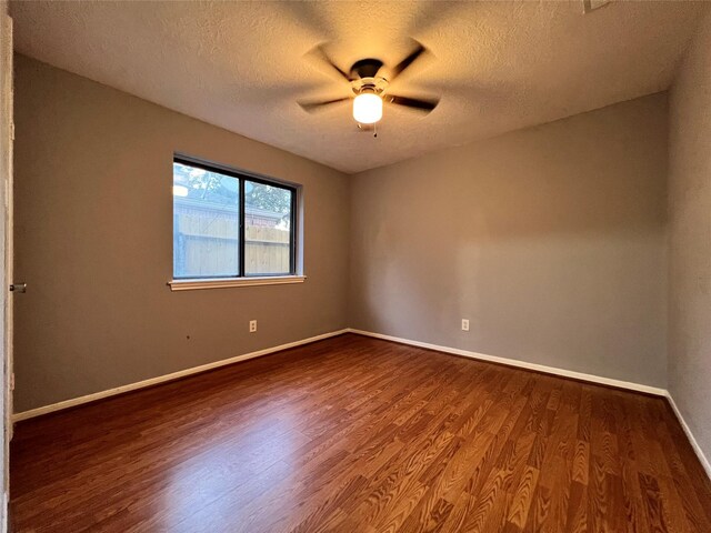 empty room featuring a textured ceiling, hardwood / wood-style flooring, and ceiling fan