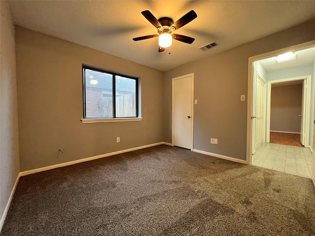 spare room featuring ceiling fan and light carpet